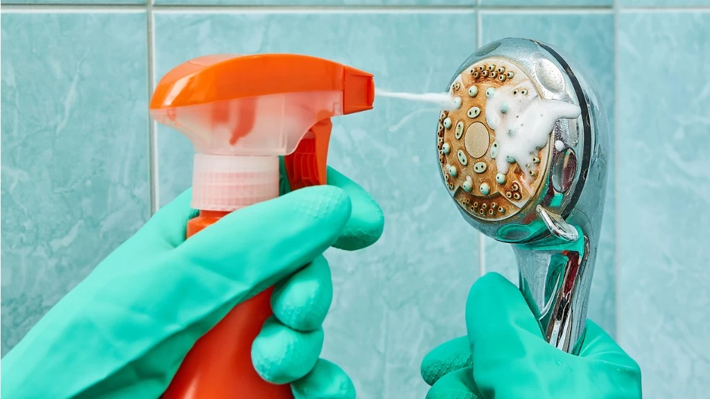 تمیز کردن رسوبات سردوش حمام به صورت دستی